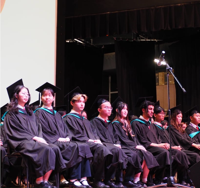 Graduating students taking the stage during the POWIIS Class of 2024 ceremony.
