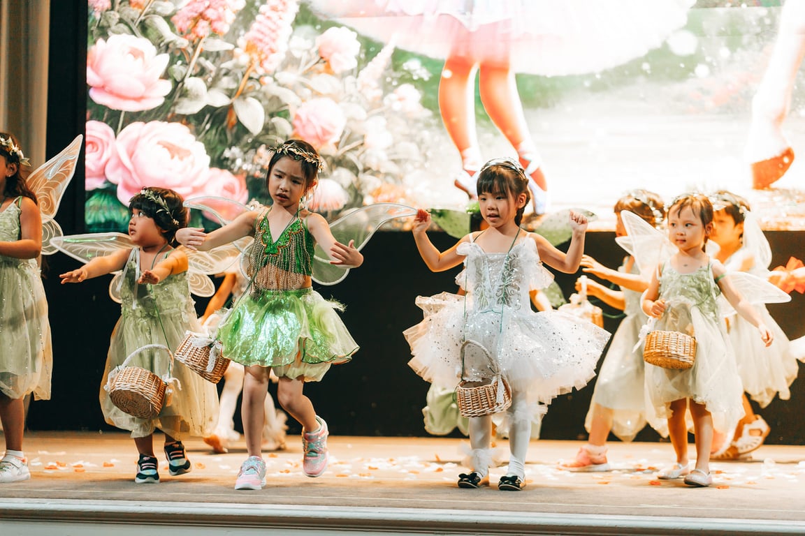Children performing on stage during graduation concert.