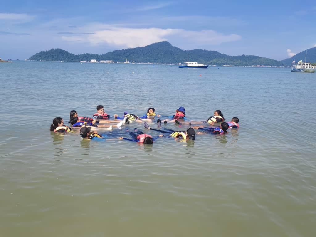 Children floating during a teamwork water activity.