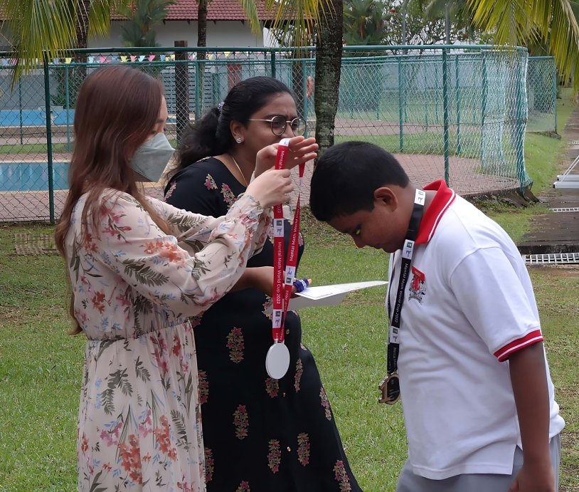Student receiving a medal during the school awards ceremony.