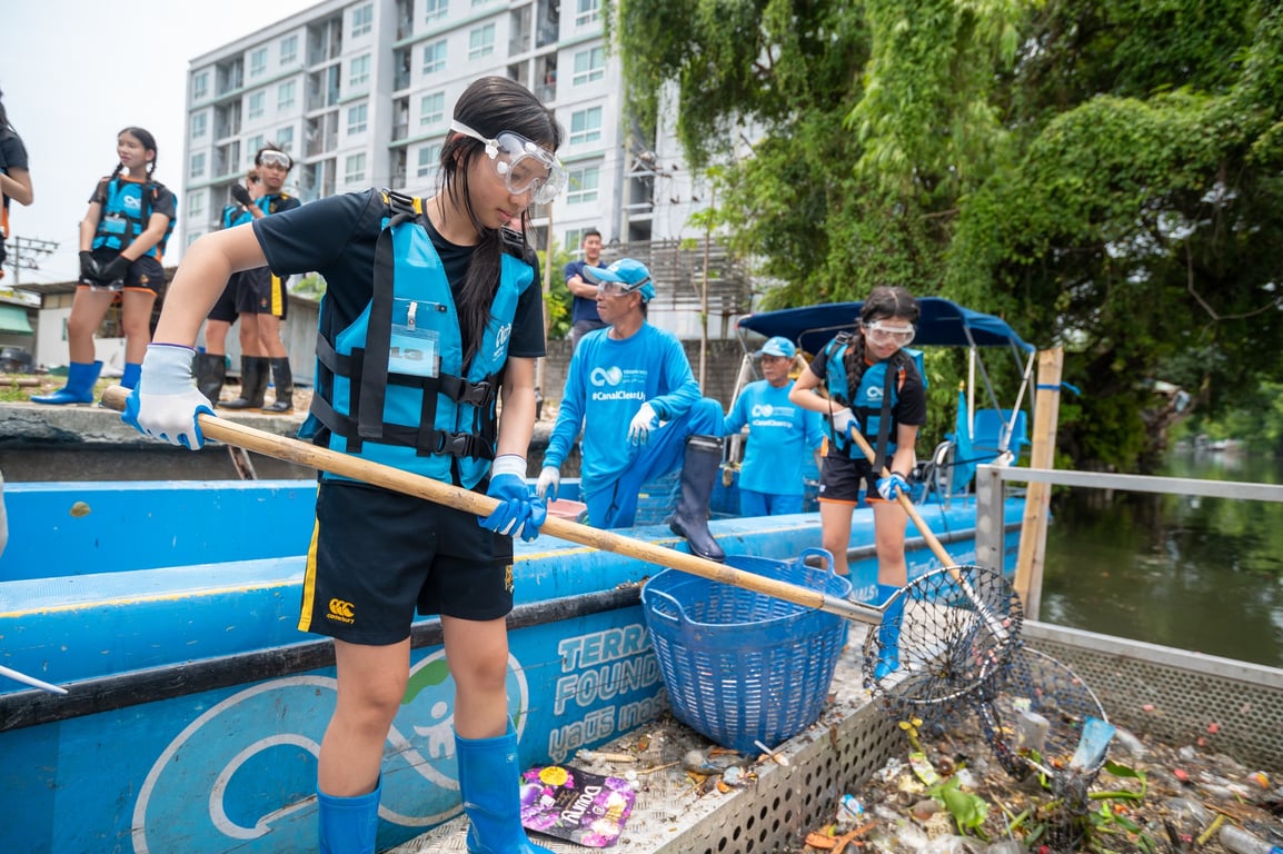 Students taking part in a community canal clean-up effort.
