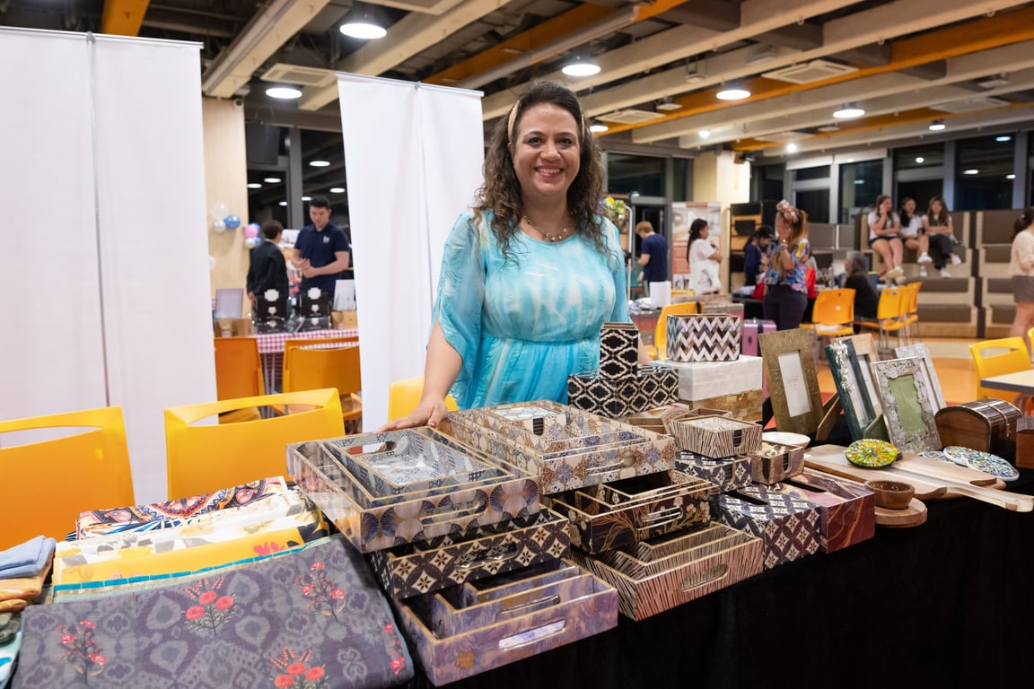 A parent displaying handcrafted trays and homeware at South Island School Nightfest 2024.