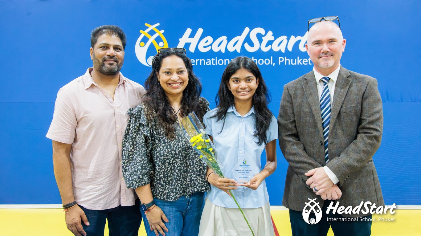 A family posing at the Year End Ceremony.