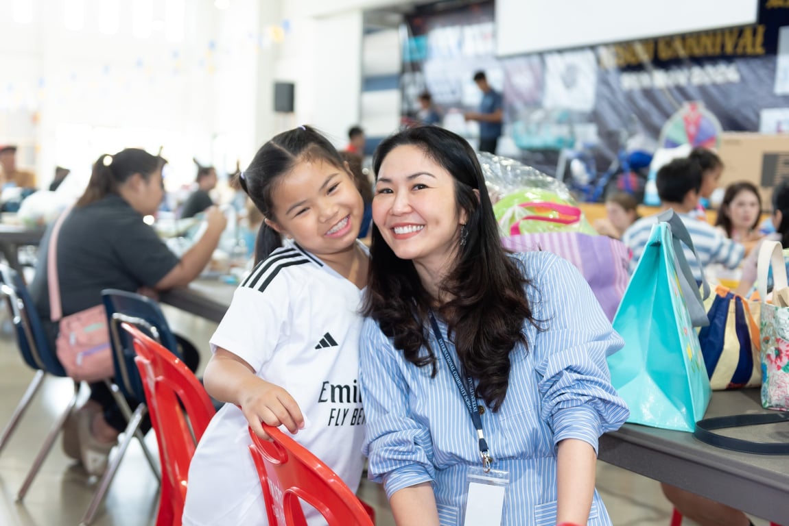 Mother and daughter posing at a mother's day event.
