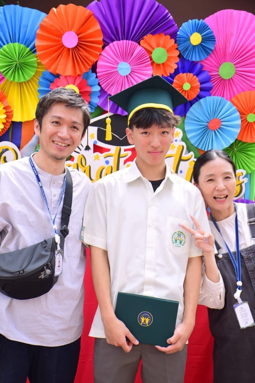 Student and family celebrating graduation together.