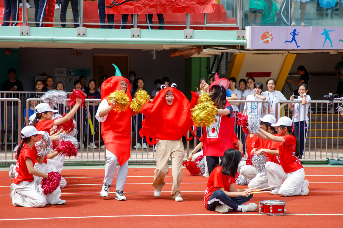 Students performing in costume during a school sports event.
