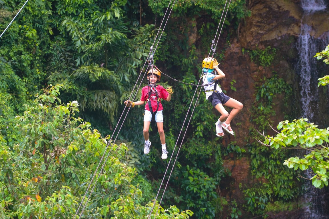 Older students take part in a zipline activity during a school trip.