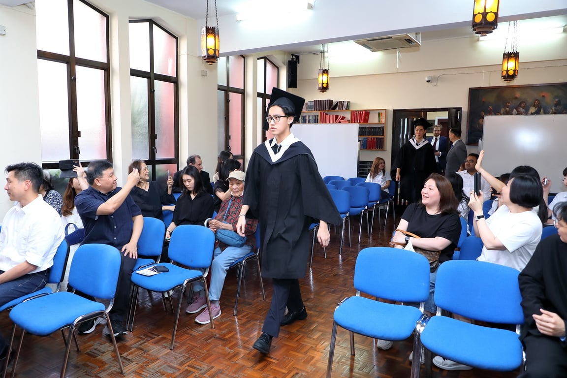 Parents capturing special moments at the graduation procession.