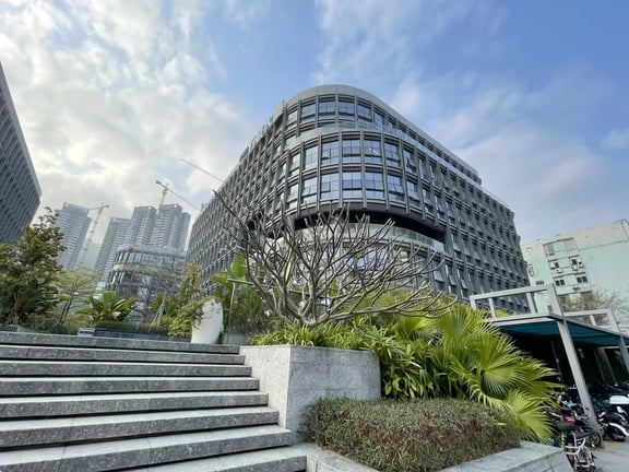 A wide view of the glass-fronted academic buildings at Shekou International School Net Valley Campus.
