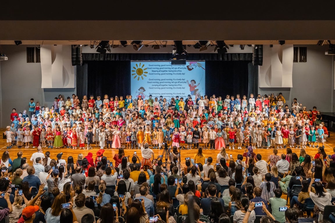 Primary school students perform a music assembly for parents in the theatre hall