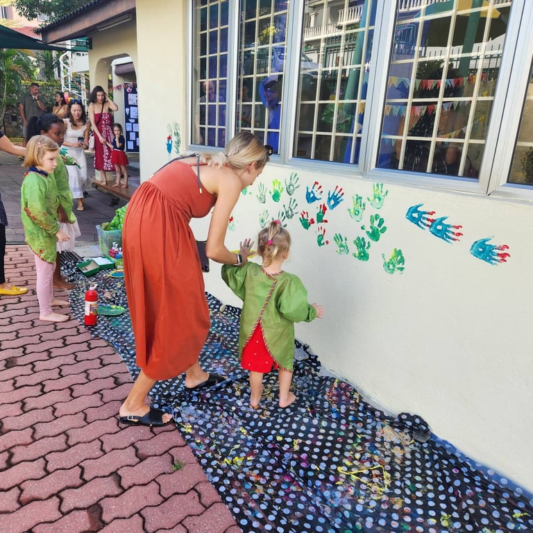 Parents and children enjoy the Kindergarten Summer Party, where they make artistic memories before moving on to the Primary school.