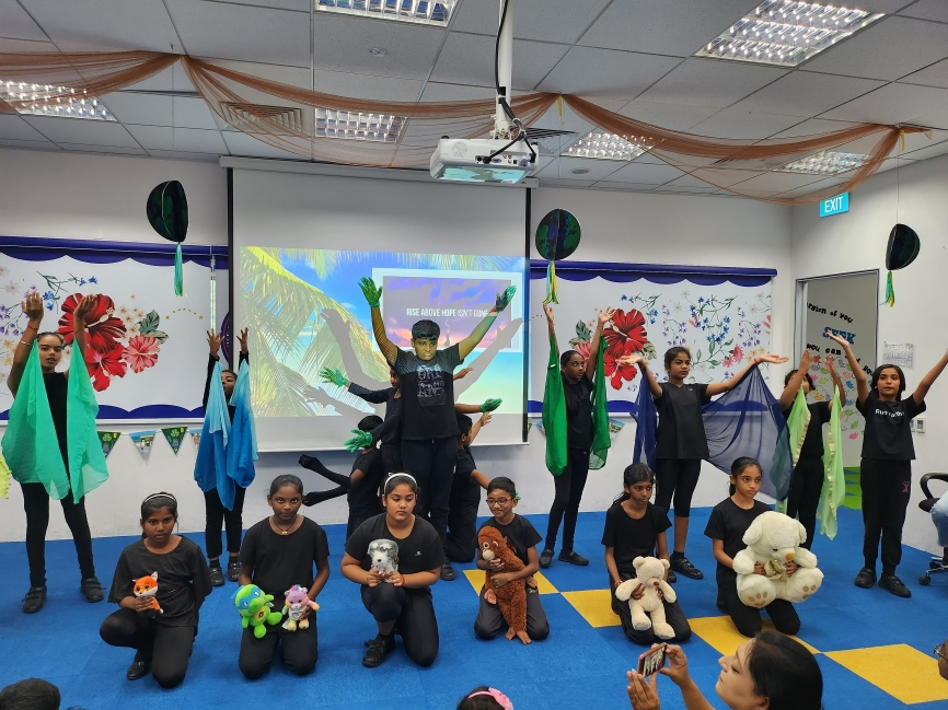 A creative group act with props and puppets during a classroom showcase.