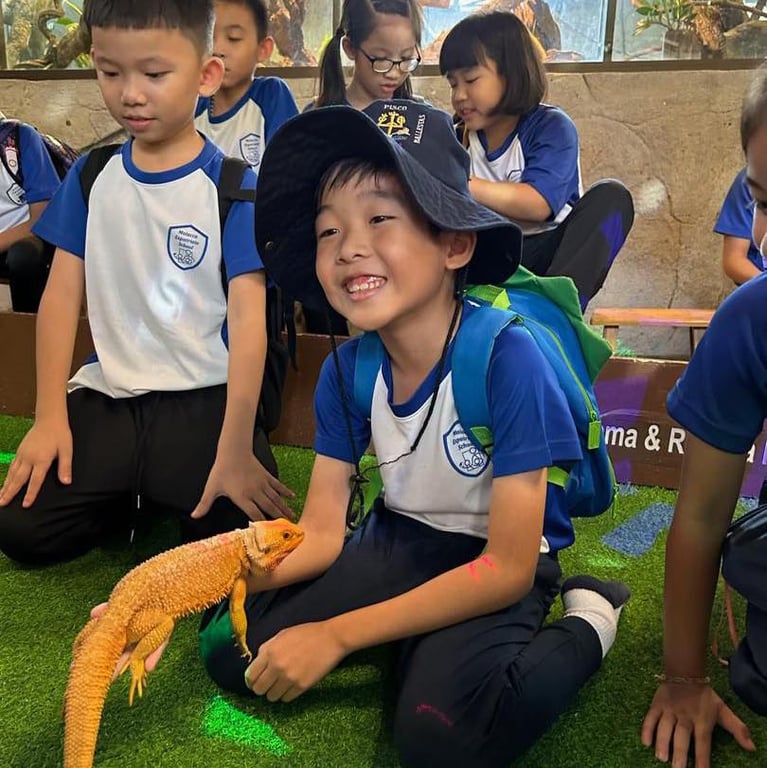 Students engage in a hands-on animal encounter during a school field trip.