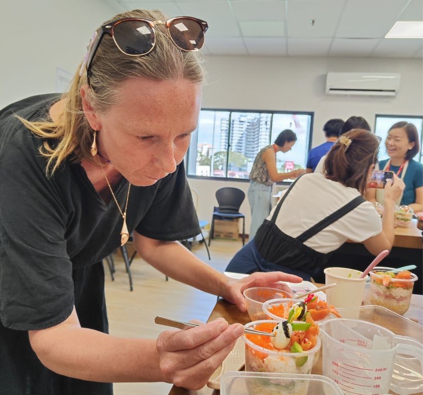 A parent seen decorating sushi cups during the Hinamatsuri cultural workshop.