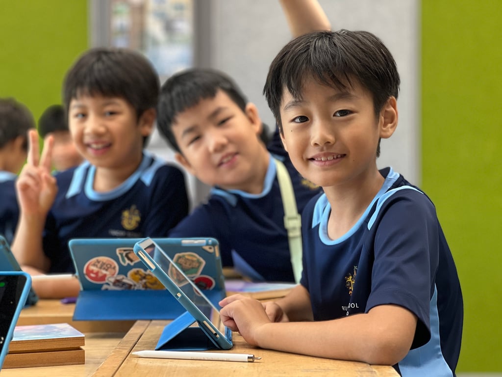 Year 4 students using iPads during their wooden maze design project.