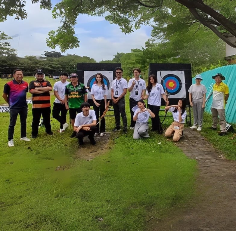 Students and coaches pose after an archery session, highlighting the school’s inclusion of unique outdoor education activities.