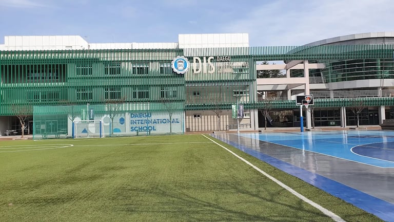Daegu International School campus with outdoor courts and field.
