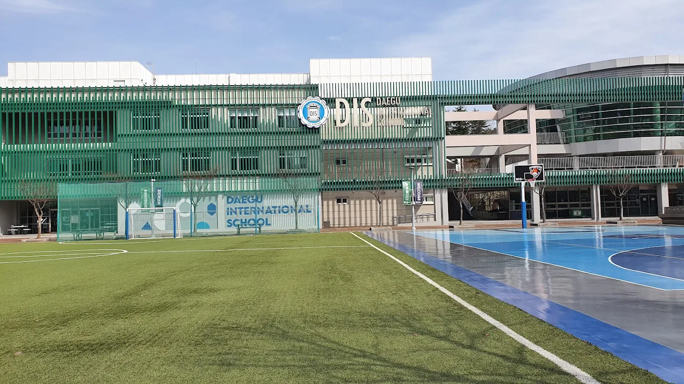 Daegu International School campus with outdoor courts and field.