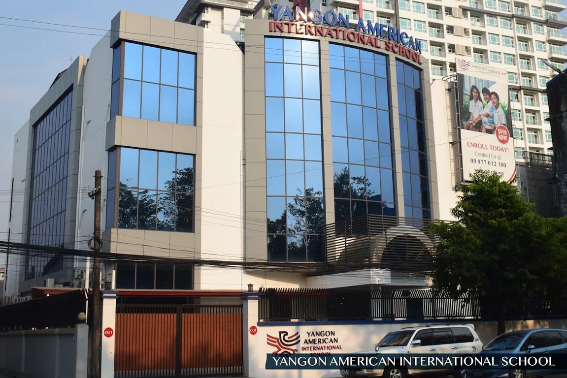 The primary school entrance and secure gate featuring official campus signage.