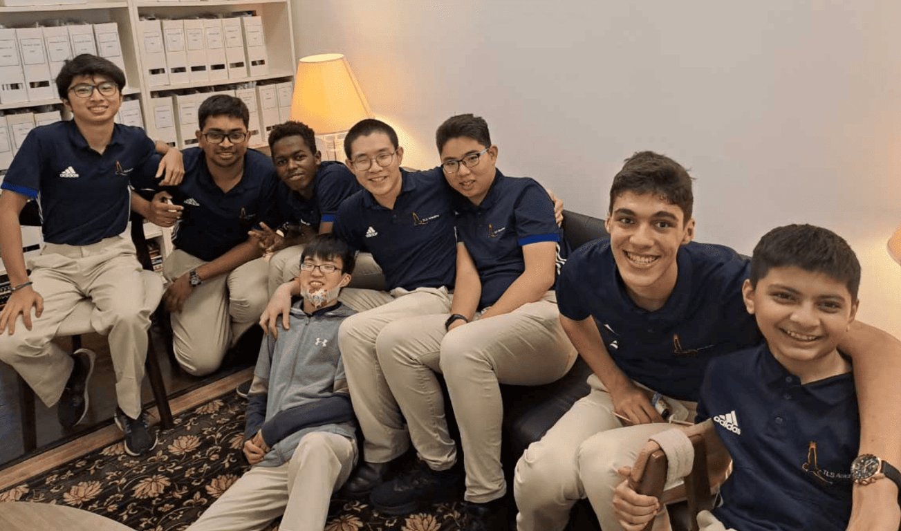 A group of students posing for a photo while enjoying their time at TLS.