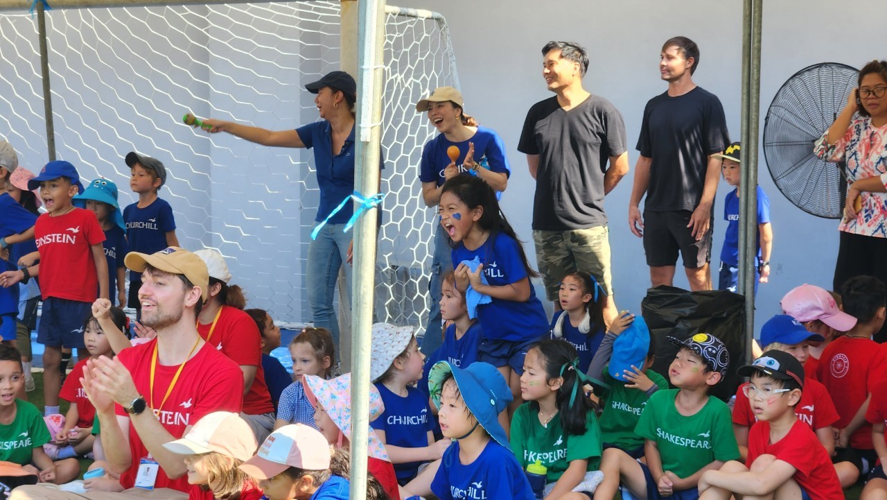 Families cheering students on during the sports day event.