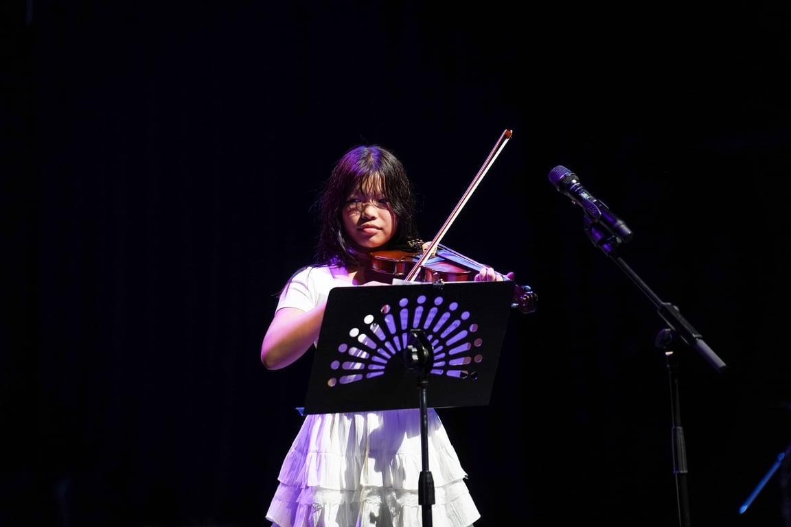 A Year 6 student performing a solo violin piece at the celebration.