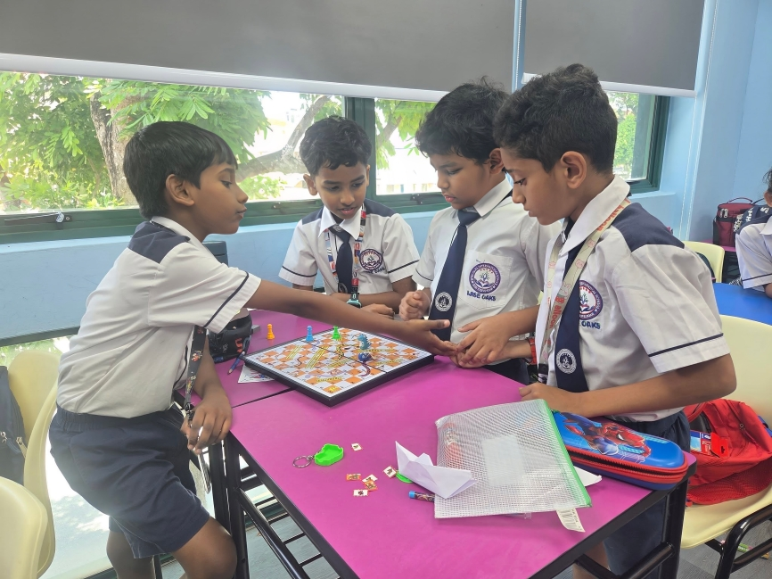 Students bond over a board game during classroom play-based learning time.