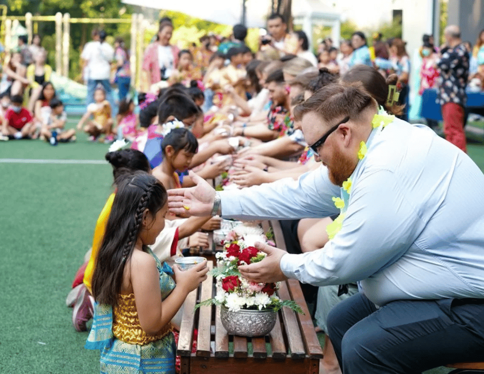 Songkran water ceremony between students and staff.
