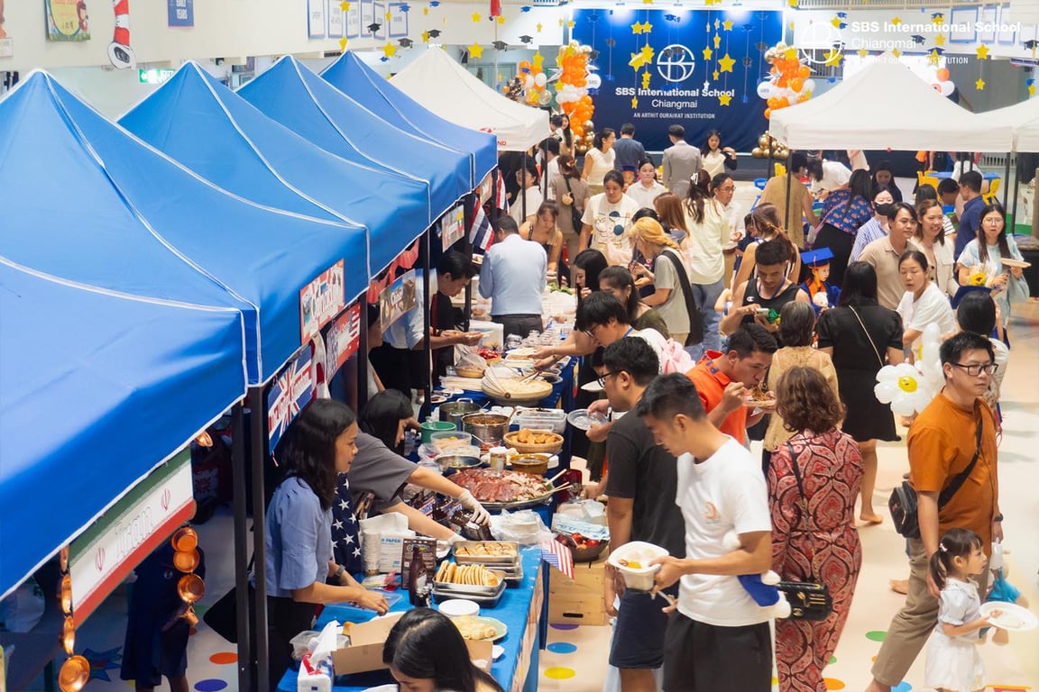 Families sharing food and culture at the SBS Chiangmai International Potluck.
