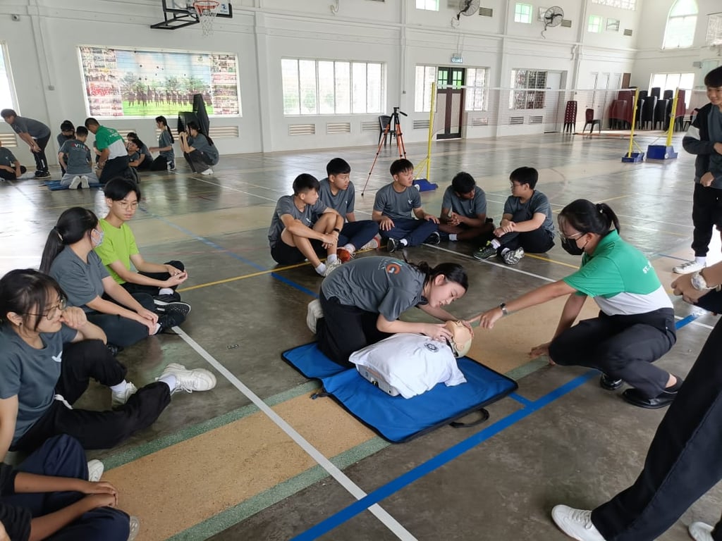 Students practicing CPR techniques during a first aid training session.