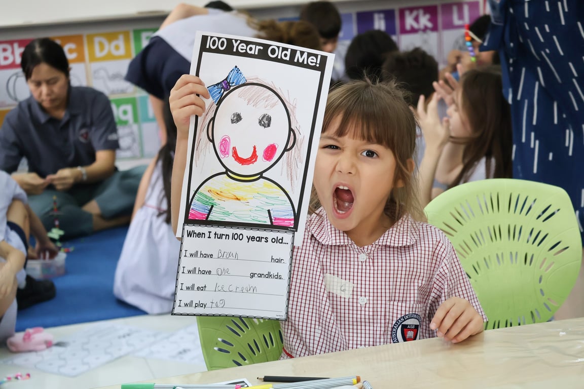 A student posing with her activity sheet.