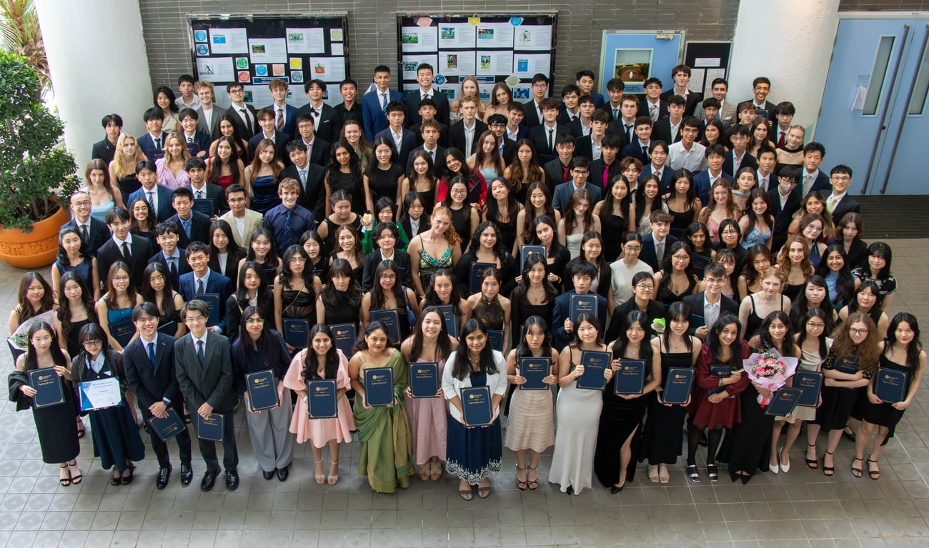 The WIS community posing at the Year 12 graduation ceremony.