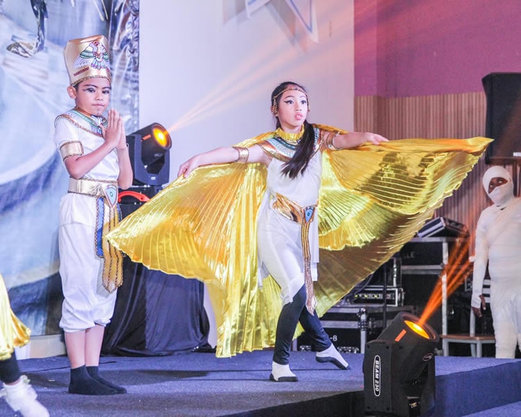 Students performing in a school stage production.