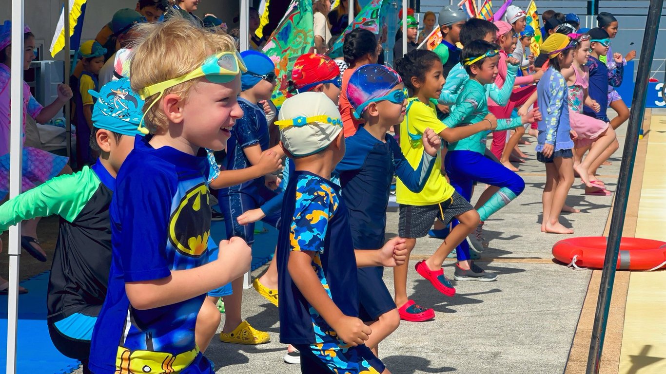 Students lining up at the start of a swimming gala.