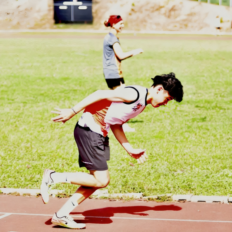 Student sprinting during the AIMS athletics competition.