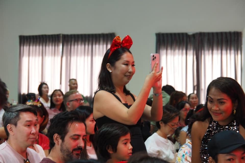Parents capturing moments during the school’s Christmas celebration event.