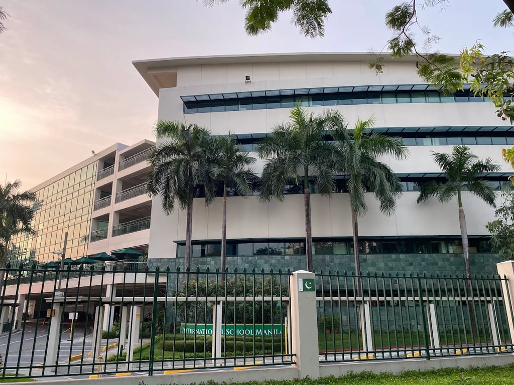 Tropical palm trees surrounding the campus building.