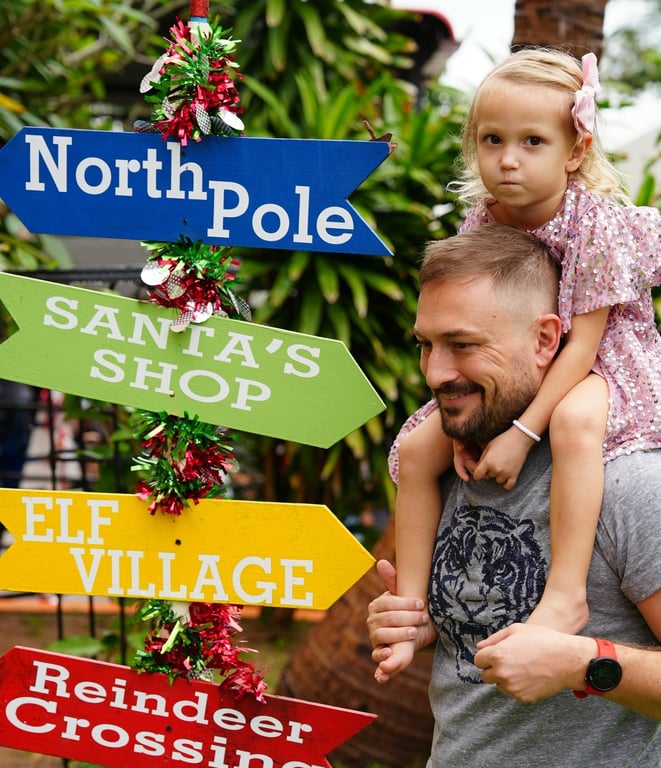 Father carrying daughter on shoulders at the Winter Holiday Show.