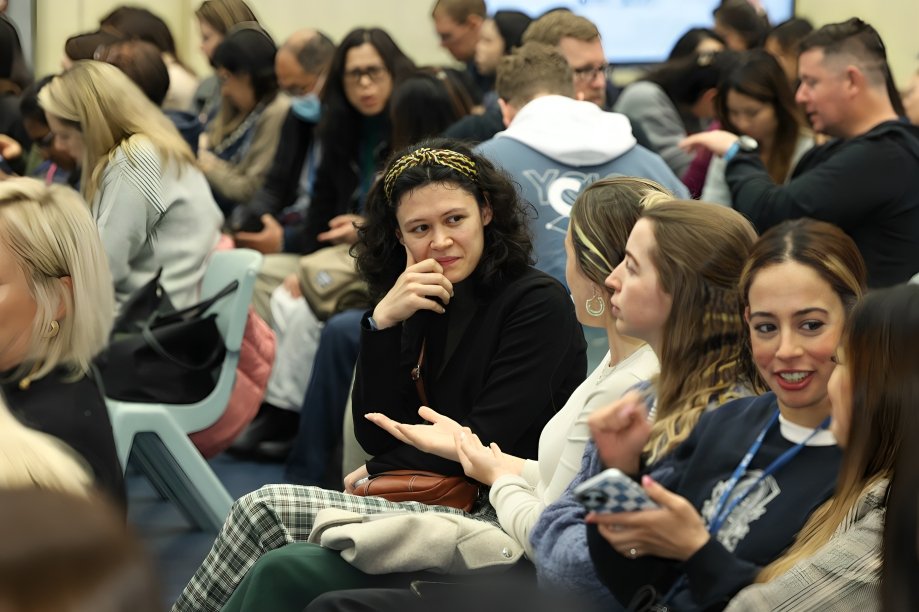 Parents engage in conversations during a school information session.