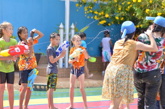 Students celebrating Songkran with water play.