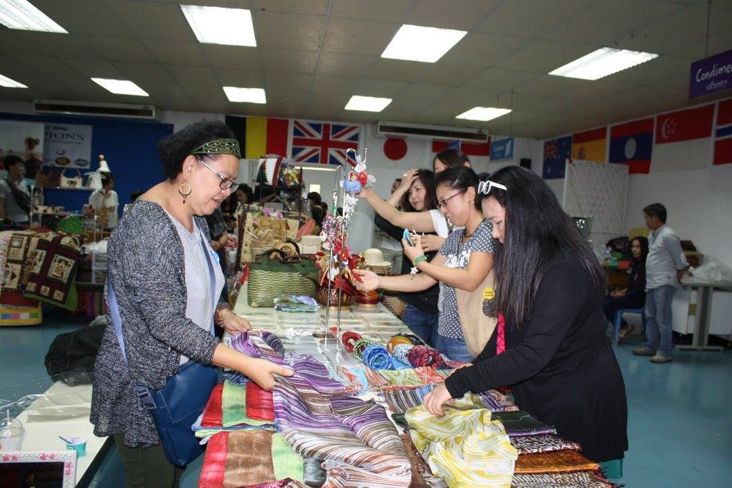Parents browsing handmade goods at the Family Fun Fair.