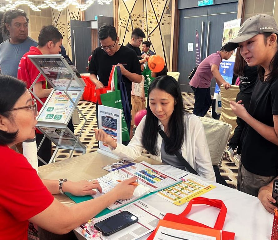 Prospective families being counselled in an education fair.