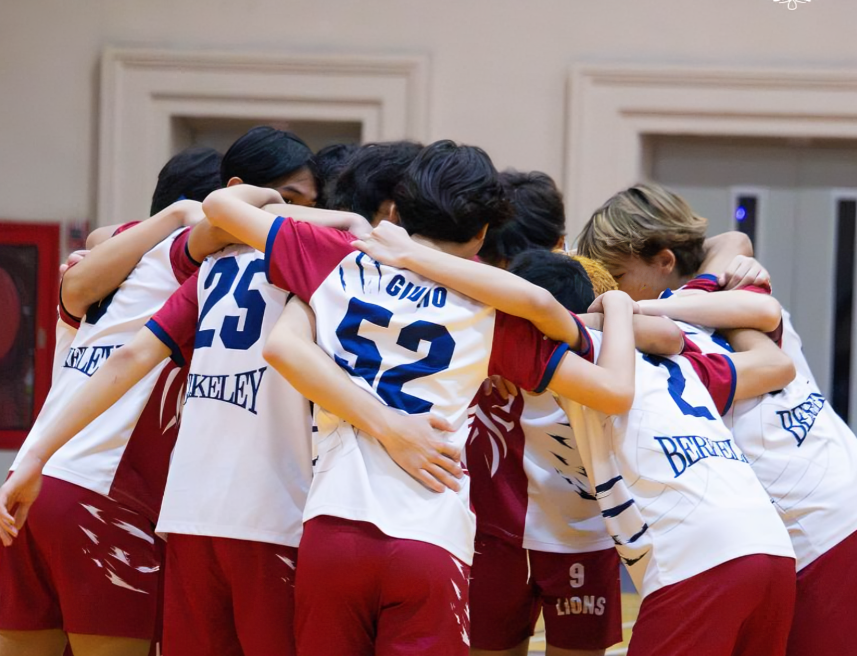 The school team gathers for a group huddle before their game.
