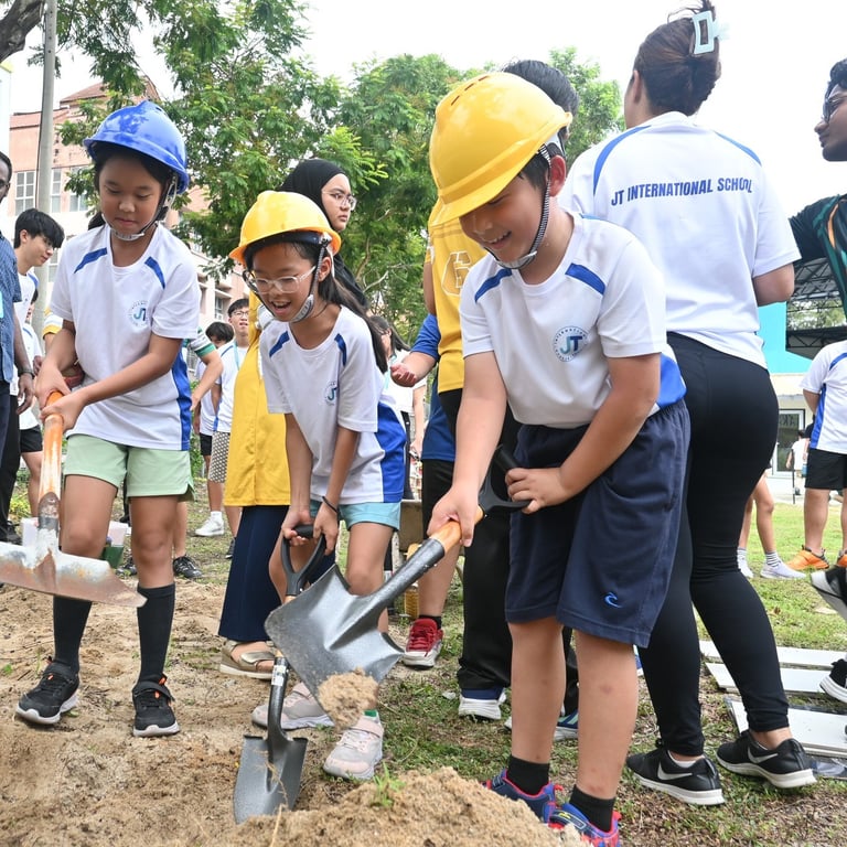 With helmets on and shovels in hand, young students contribute to environmental efforts by planting trees on campus grounds.