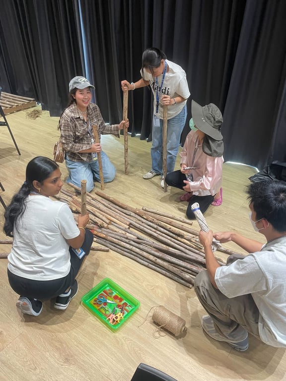 Pre-Prep parents building wooden structures during the Forest School workshop.