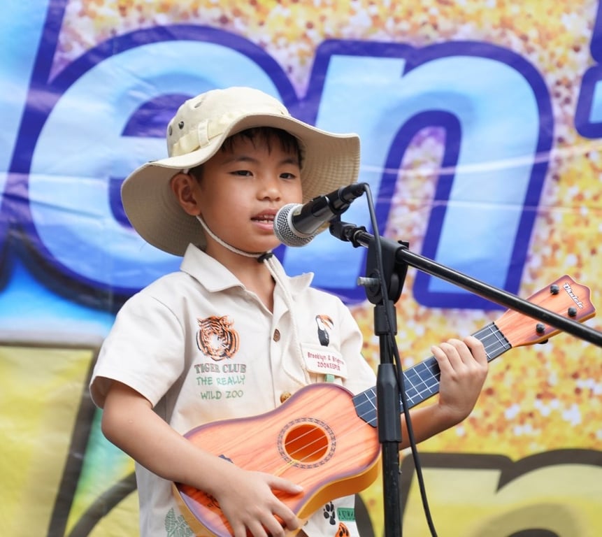 Student performing at the school talent show with ukulele.