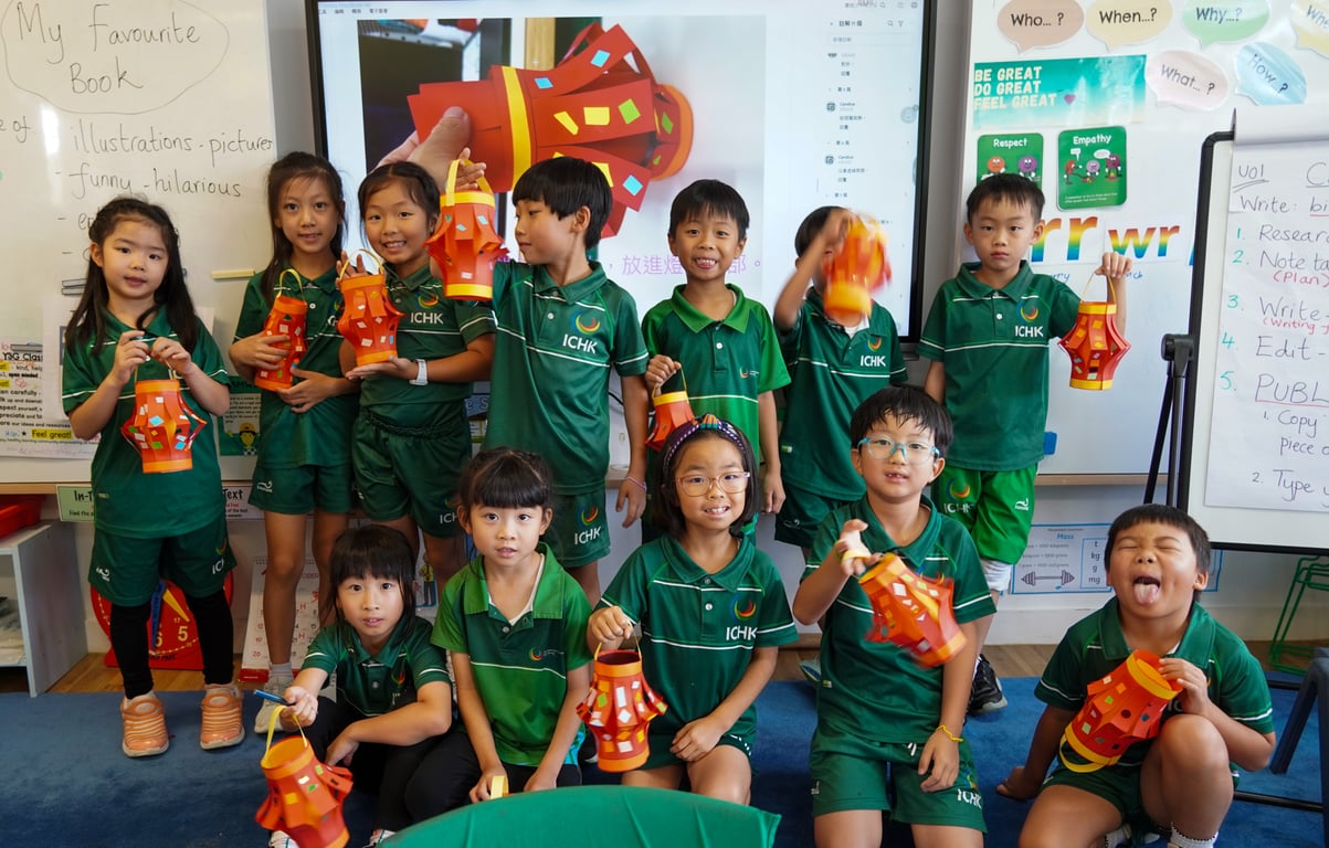 ICHK Primary students proudly displaying their handmade lanterns during a joyful Mid-Autumn Festival celebration in Chinese class.