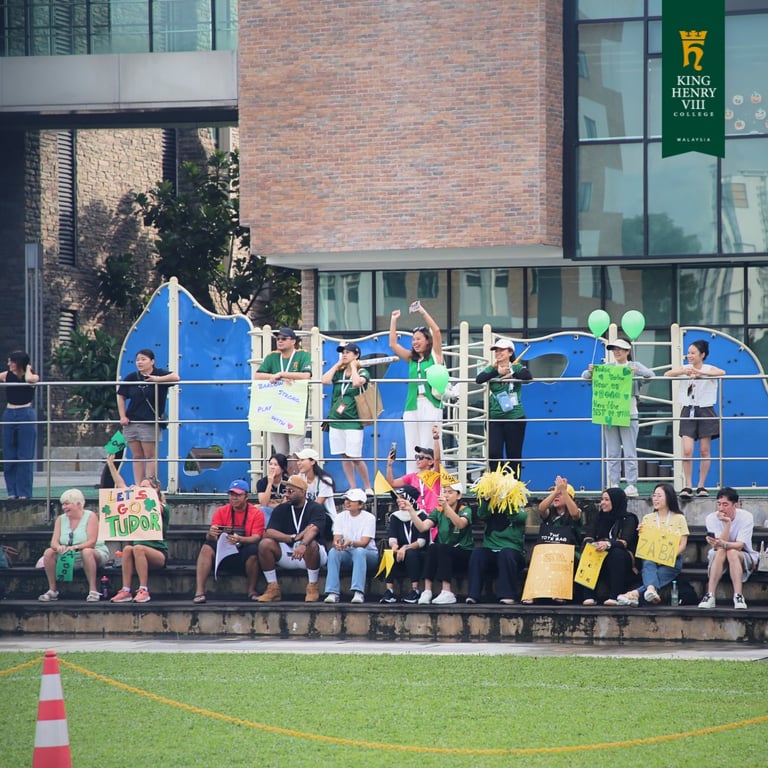 Parents and families cheering from the stands on Sports Day.