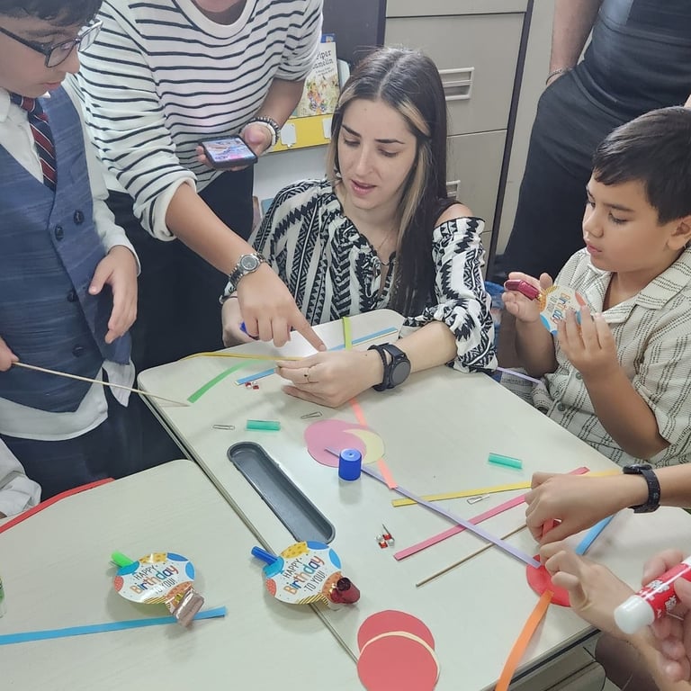 Parents join the Year 1 classroom for a craft lesson, bringing an end to their unit on global festivals.