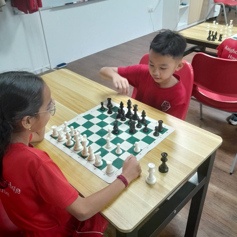 Two students competing in the Chess Tournament hosted by KHIS
